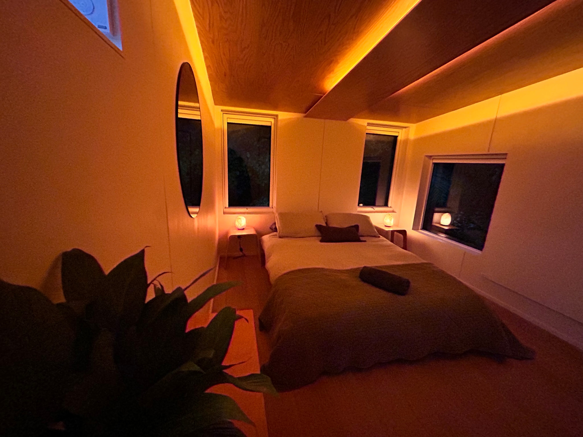 The Pod bed at night lit by warm salt lamps